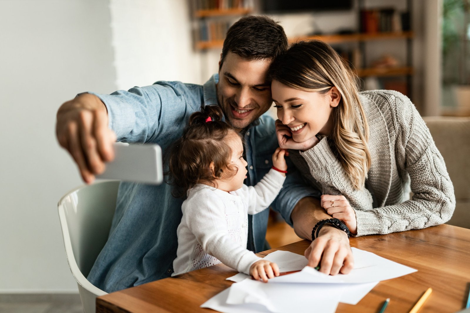 Insurance Blog,Young family having fun while taking selfie at home.